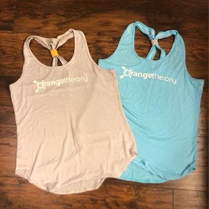 Two Orange Theory tank tops